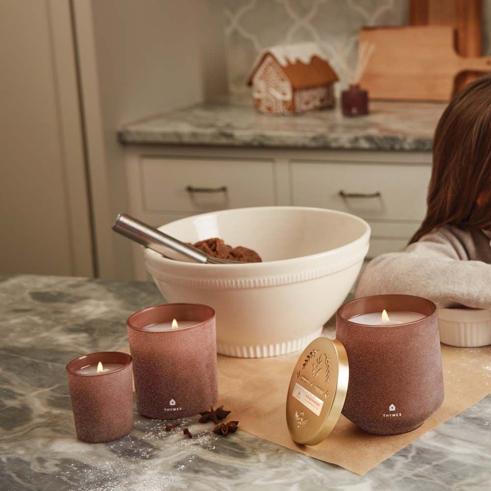 Thymes Gingerbread Large Candle is a Holiday Fragrance next to mixing bowl and Gingerbread Candles on kitchen countertop image number 3
